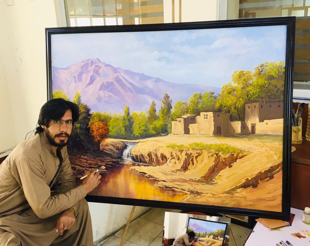 The artist at work on a river landscape